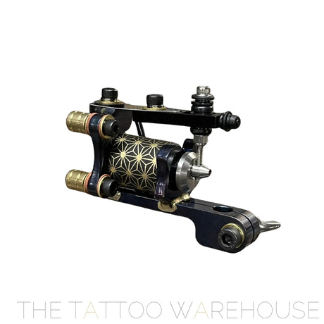 Close up of the eruhiga grand line tattoo machine. it is rotary powered with a distinctive armature bar and back spring similar to a coil. Blue and black in colour with geometric patterns on the motor.