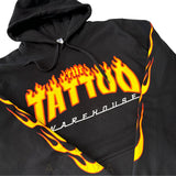 Close Up of The Tattoo Warehouse Logo and flames running down the arms of Jumper with hoodie.