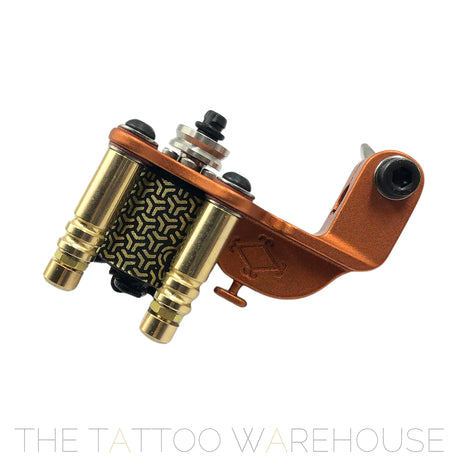 A Beautiful closeup of the Era Higa Quinke v.2s. Its aluminium frame is orange. The Foulhaber motor has a geometric pattern originating from Japan. The best and most beautiful rotary tattoo machine one the market.