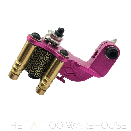 A Beautiful closeup of the Era Higa Quinke v.2s. Its aluminium frame is pink. The Foulhaber motor has a geometric pattern originating from Japan. The best and most beautiful rotary tattoo machine one the market.