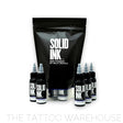 Five 1 ounce bottles of solid SMP inks standing up around a bag of SMP Pigment by Billy Decola.